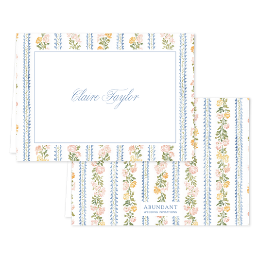Folded notecard set with floral stripe pattern and custom script name on white paper