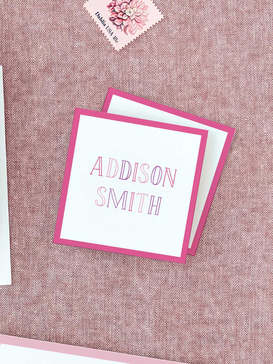 Square pink-bordered calling cards with elegant pink outlined letters on white, personalized for event or wedding stationery.