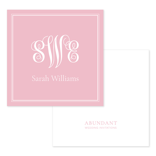 Square blush pink calling card with elegant white script monogram and personalized name, paired with a white envelope featuring subtle blush branding.