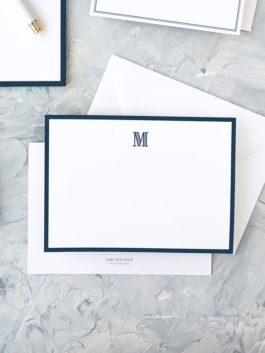 Elegant flat notecard featuring a classic navy border and a centered monogram, perfect for personalized stationery and timeless correspondence.