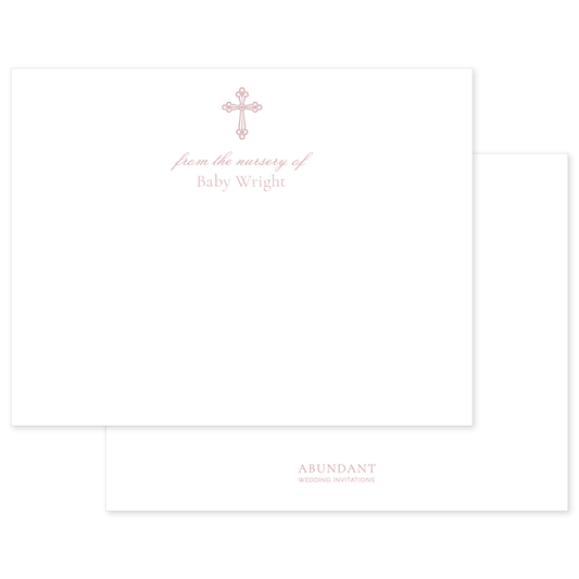 Elegant flat notecard featuring a delicate pink cross and personalized nursery text in soft script on high-quality white stationery.