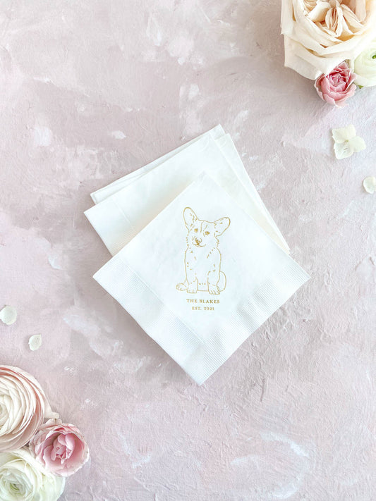 White cocktail napkin featuring a simple gold pet illustration and personalized text on a soft pink background.