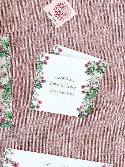 Square calling card with delicate pink floral border and personalized elegant green script on textured background