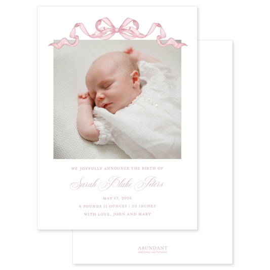 Birth announcement with a newborn baby photo with pink ribbon and script name on a white background