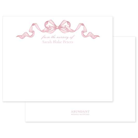 Elegant notecard featuring a soft pink watercolor bow and personalized nursery text in graceful script on white background.