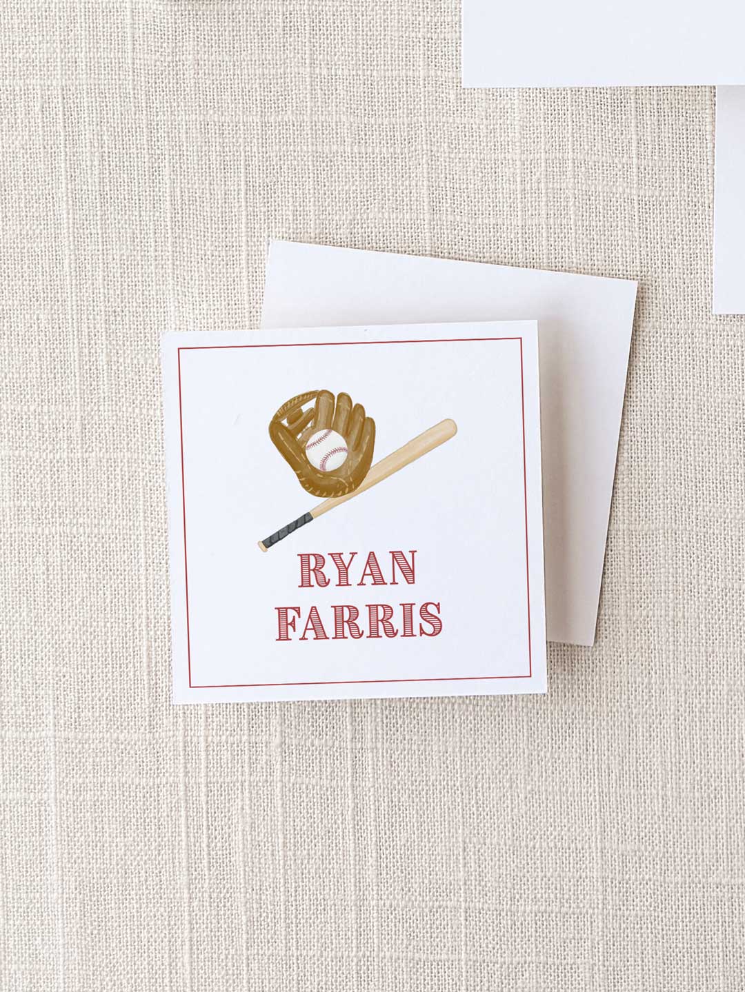 Square calling card with a baseball glove holding a ball and a bat illustration above the personalized name in classic red text on a textured neutral background.