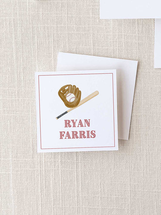 Square calling card with a baseball glove holding a ball and a bat illustration above the personalized name in classic red text on a textured neutral background.