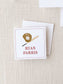 Square calling card with a baseball glove holding a ball and a bat illustration above the personalized name in classic red text on a textured neutral background.