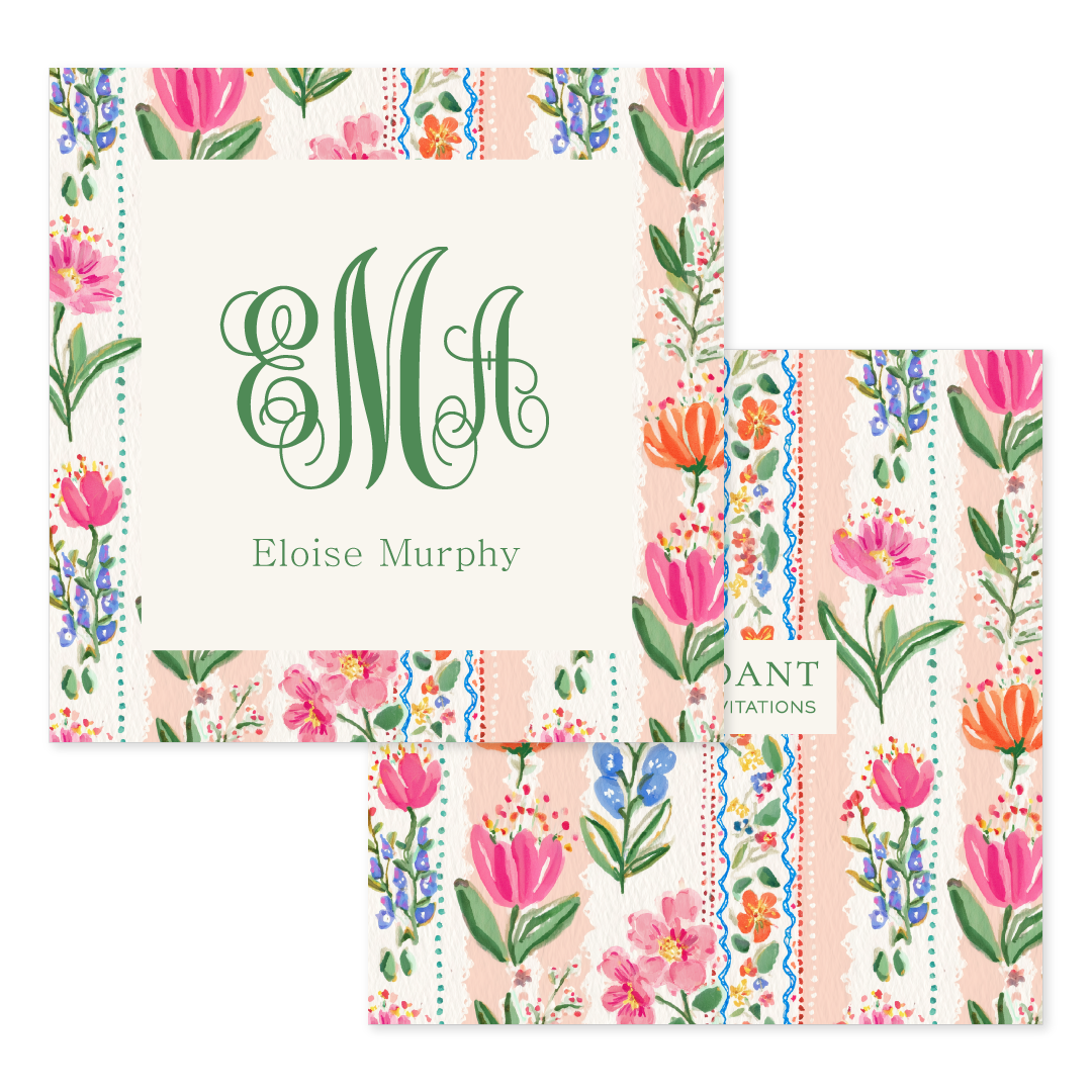 Calling card with floral border featuring pink, orange, and blue blossoms and elegant green monogram initials.