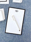 Personalized notepad featuring a classic black border and elegant monogram, displayed with a white pen on textured fabric background.