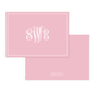 Elegant folded notecard in soft blush pink featuring a white monogram and classic border design, perfect for personalized stationery.