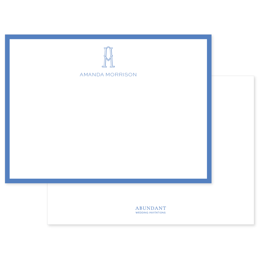 Flat notecard bordered in cobalt blue with elegant monogram and personalized name centered at the top, showcasing timeless, classic design.