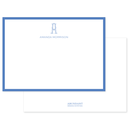 Flat notecard bordered in cobalt blue with elegant monogram and personalized name centered at the top, showcasing timeless, classic design.