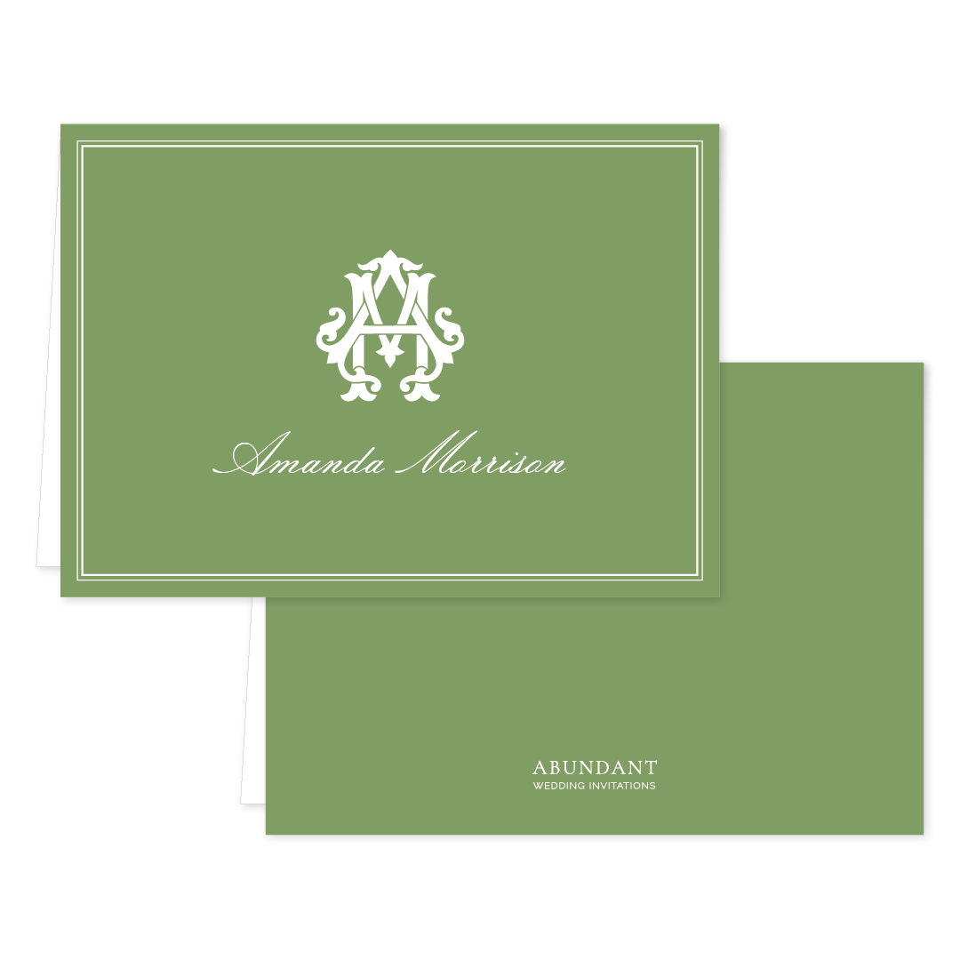 Folded green notecard with elegant white monogram and cursive name on front, simple matching back featuring subtle branding.