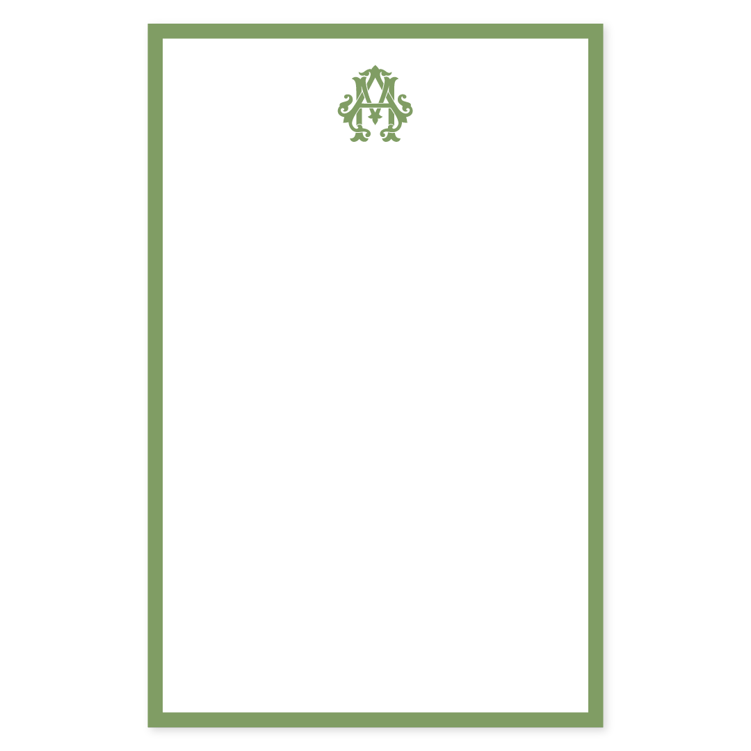 Elegant notepad page featuring a classic green border and a decorative monogram design at the top, ideal for personalized stationery.