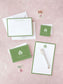 Personalized classic green stationery set featuring a notepad, note cards, and envelopes with elegant monogram and border accents.