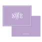 Folded lavender notecard with elegant white monogram initials in the center, bordered by a double-line frame, personalized stationery for special occasions.