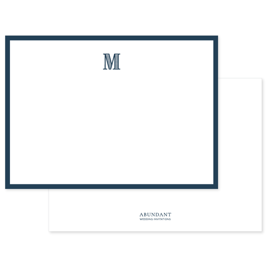 Flat white notecard with a classic navy blue border and a bold navy monogram letter M at the top center, personalized stationery design.