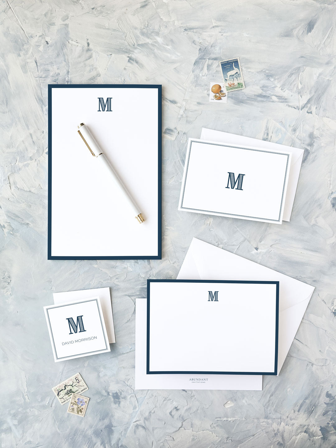 Elegant personalized stationery set featuring navy border and a classic monogram, ideal for timeless wedding invitations or formal correspondence.