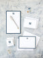 Elegant personalized stationery set featuring navy border and a classic monogram, ideal for timeless wedding invitations or formal correspondence.