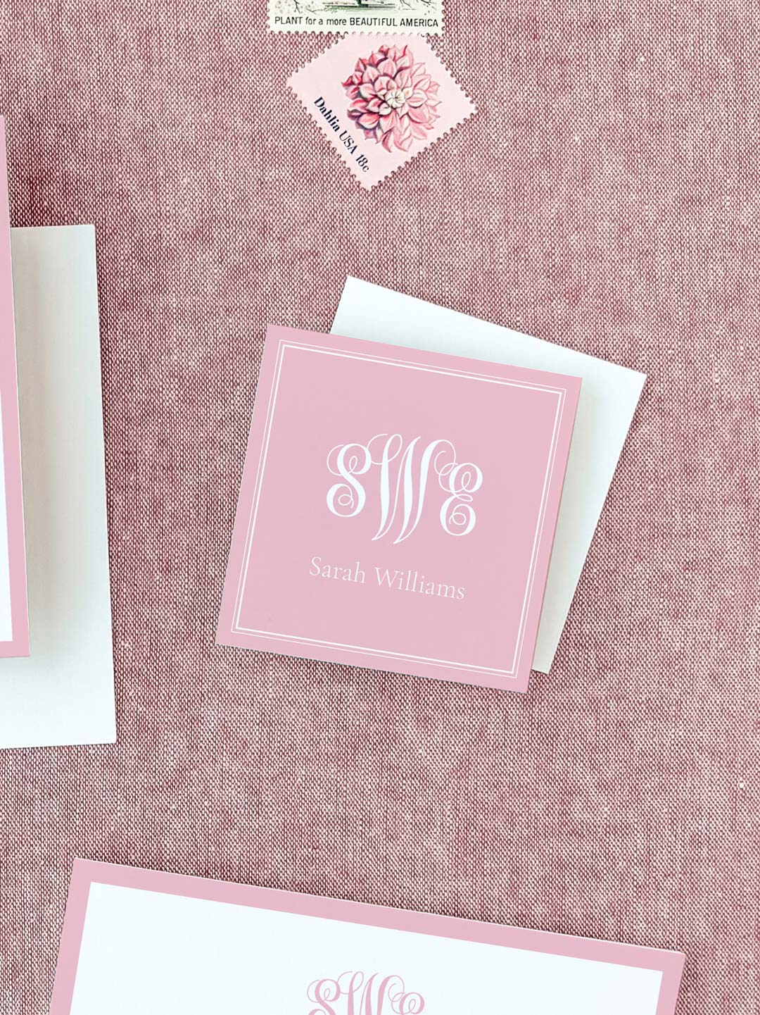 Square personalized calling card in soft blush pink with elegant white monogram and name on textured fabric background