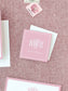 Square personalized calling card in soft blush pink with elegant white monogram and name on textured fabric background