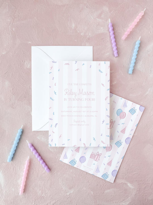 Pink and white striped birthday invitation with confetti and pastel birthday candles on a textured surface