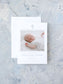 A classic blue-accented birth announcement card featuring a sleeping baby photo and a delicate cross design on white personalized stationery.