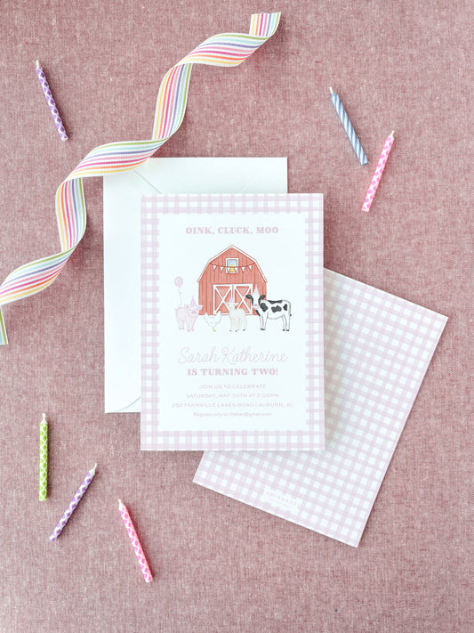 Pink farm animal-themed birthday invitation with barn, cow, and pig illustrations on gingham background