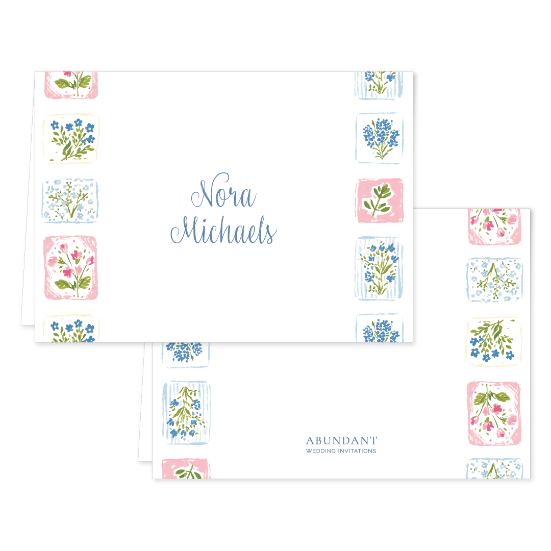 Folded notecard with delicate blue and pink floral tile border and elegant handwritten name in center