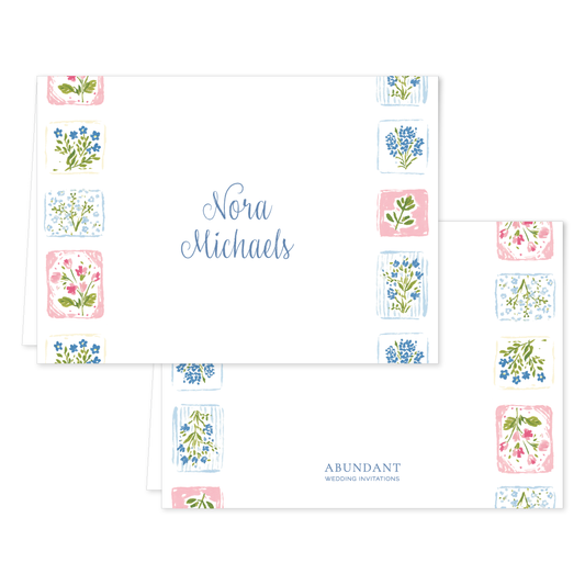 Folded notecard with delicate blue and pink floral tile border and elegant handwritten name in center