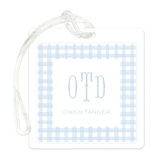 Clear luggage tag featuring a soft blue gingham pattern with elegant monogram initials and a personalized name in light blue font.