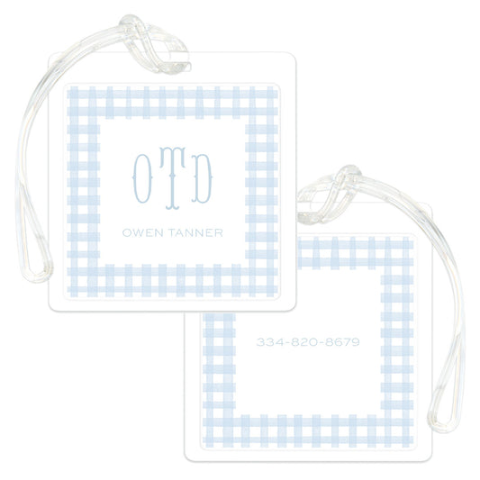 Square luggage tag with a light blue gingham pattern border, personalized with initials and name on one side and a phone number on the other.