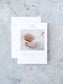 Elegant blue and white birth announcement card featuring a sleeping newborn photo with a monogram and personalized details on textured background.