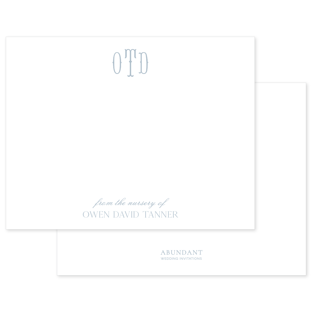 Elegant white stationery card featuring a soft blue monogram and personalized nursery text with classic, timeless design elements.