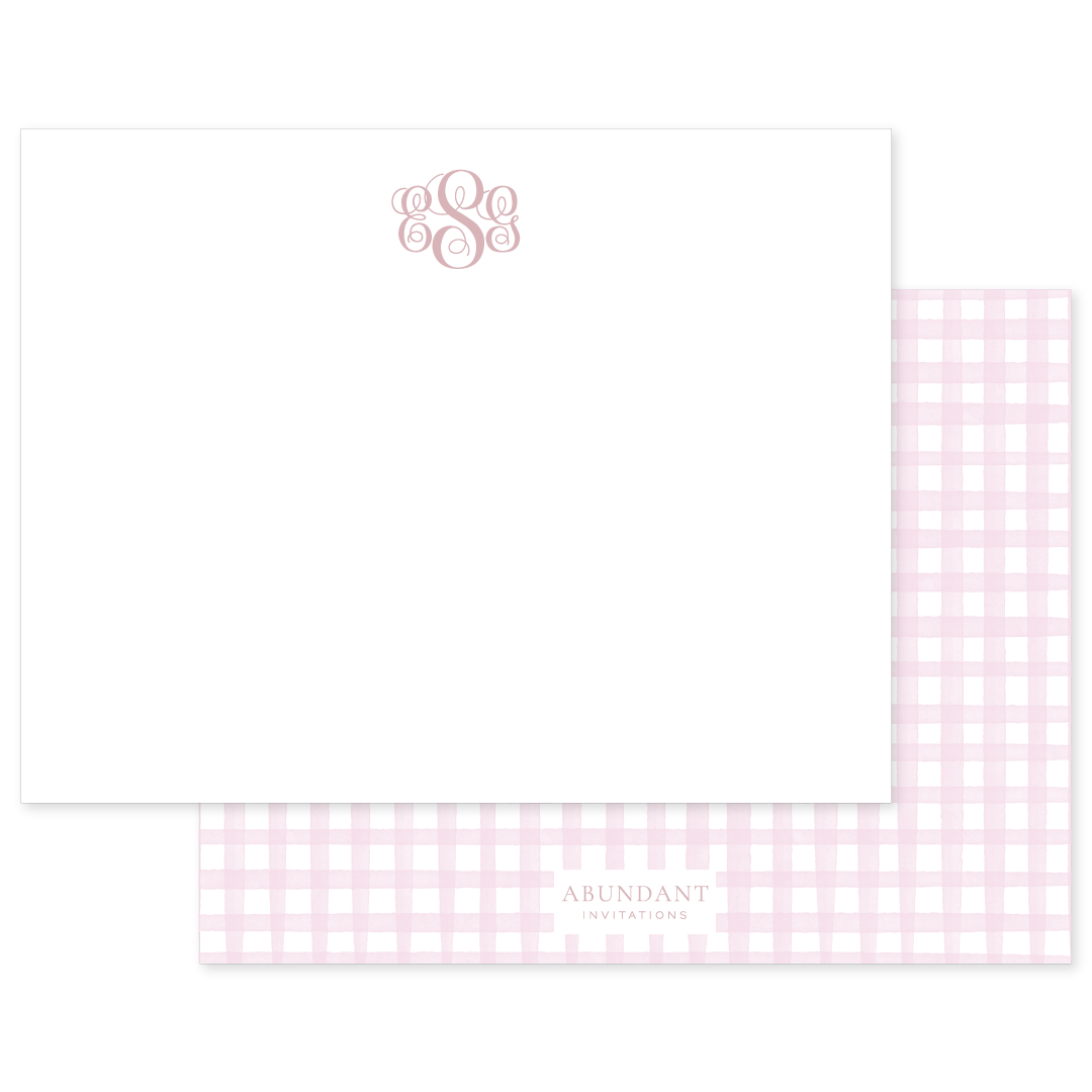 Elegant flat notecard featuring a soft pink gingham pattern on the back and a personalized monogram in a classic script on the front.