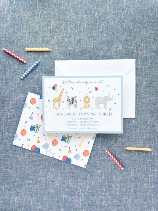 Birthday invitation with colorful party animals and festive decorations on a textured blue background