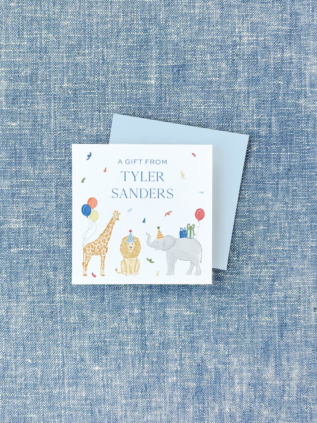 Colorful personalized calling card featuring watercolor illustrations of a giraffe, lion, and elephant wearing party hats with balloons and gifts on a textured blue background.