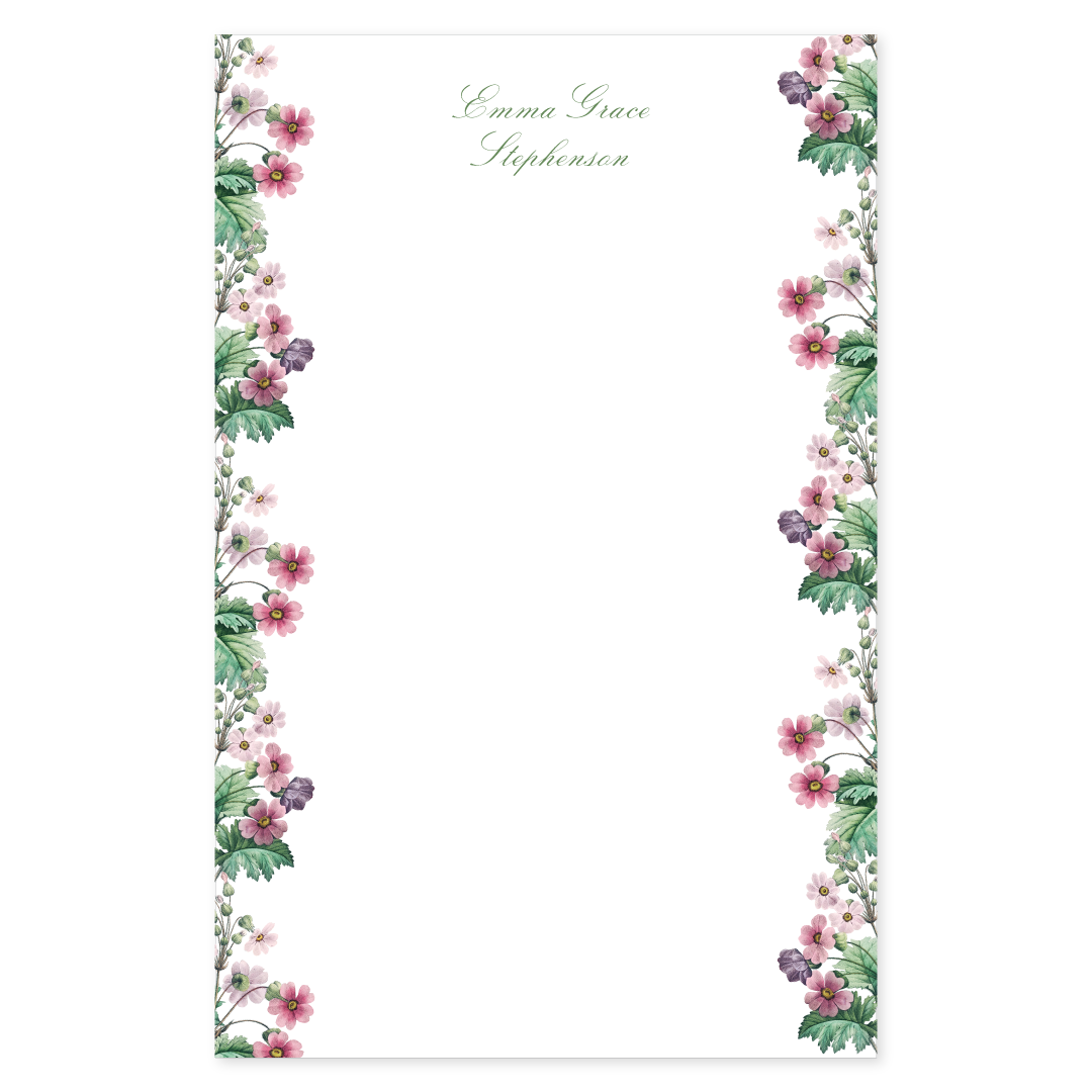 Notepad with a primrose floral border design with pink flowers and a script custom name on a white background