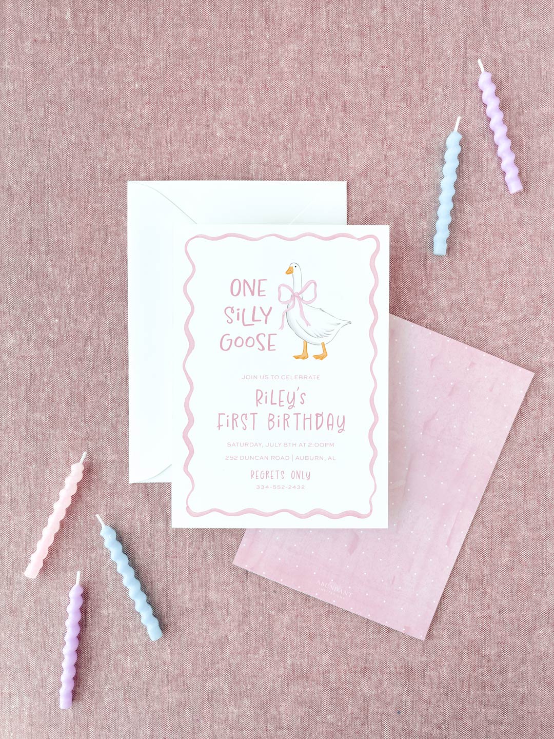 Birthday invitation card with a playful goose illustration and pink decorative border, styled with pastel candles and a soft pink background.