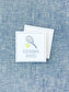 Square personalized calling card featuring a tennis racket and ball illustration with a classic serif name printed below on a blue textured fabric background.