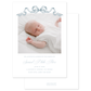 Newborn baby photo with birth announcement text and dusty blue watercolor bow on a white background