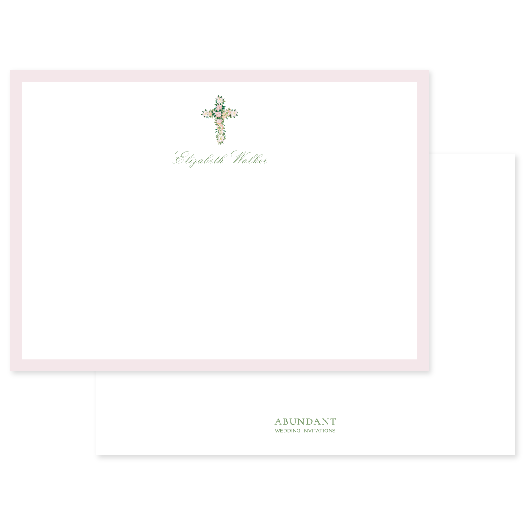 Flat notecard featuring a delicate watercolor floral cross with personalized name in elegant script, surrounded by a soft pink border.