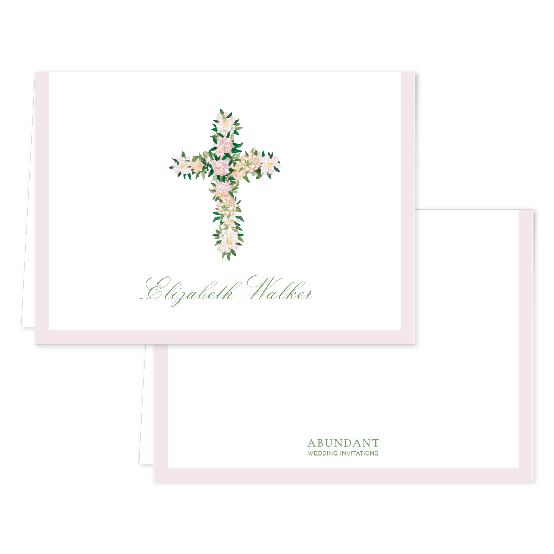 Folded notecard featuring a delicate watercolor floral cross design with personalized calligraphy name and soft pink border for timeless stationery.