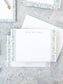 Elegant personalized flat notecard with watercolor floral stripe border in soft blue and green hues on white background.